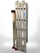 Two aluminium folding ladders. Largest max extending length 4 m.