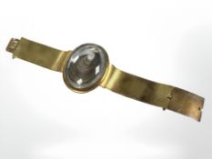 A late-Georgian pinchbeck memorial bracelet, with lock of hair set in oval panel,