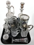 A group of decanters, pair of pressed glass candlesticks, vases including silver-rimmed example,