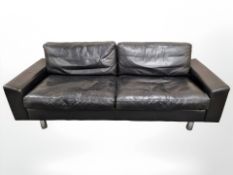 A late 20th century Danish black leather three seater settee on chrome legs,