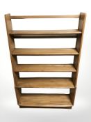 An Ercol elm waterfall open bookcase,
