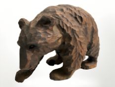 A Black Forest style carved wooden bear, length 18 cm.