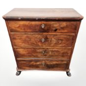 A 19th century continental walnut four drawer chest on paw feet,
