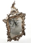 An early 20th century gilt plaster Rococo style mirror, 95 cm x 55 cm.