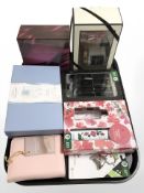 A group of boxed cosmetic gift sets, scented candles, keyring, etc.