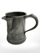 A 19th century pewter tankard with spout, height 15 cm.