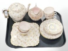 A Sixteen-piece Tuscan china tea set, gilt-rimmed with pink and gilt floral decoation,