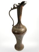 An Eastern embossed copper ewer, height 36 cm.