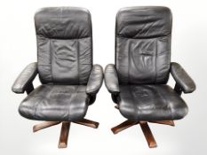 A pair of 20th century Scandinavian stained bent wood black leather swivel armchairs