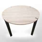 A Scandinavian limed oak circular dining table on metal legs and a non matching set of four oak
