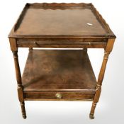 A reproduction burr yew two tier occasional table, fitted a drawer, width 46 cm.