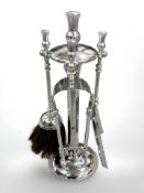A vintage chrome-plated fire companion set with thistle decoration,