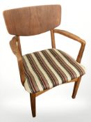 A 20th century Danish teak armchair in striped upholstery.