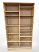A Danish blonde oak veneered open bookcase with adjustable shelves, width 108 cm.