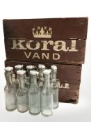 Two painted pine Koral bottle crates and a quantity of bottles, width 42 cm.