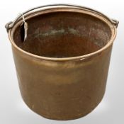 An antique copper bucket with iron handle,
