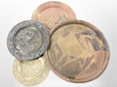 Four embossed brass chargers,