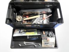 A plastic toolbox containing new and used hand tools and hardware.