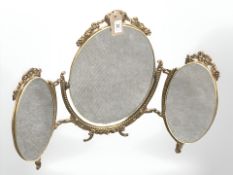 A 20'th Century ornate three-way gilt metal dressing table mirror,