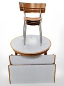 A Danish teak and melamine circular extending two two leaves,