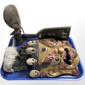 An oriental polychrome painted mask, further masks,