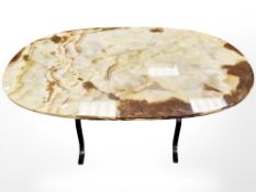 A wrought metal framed oval onyx topped occasional table, length 105 cm.