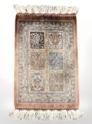 A silk rug of Ghom design,
