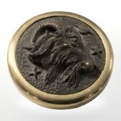 A brass mounted paperweight representing Capricorn, diameter 6 cm.