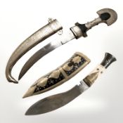 A decorative kukri knife in brass mounted sheath with bone handle,