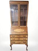 An early 20th century walnut fall front bureau bookcase,