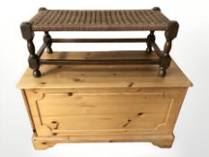 A modern pine blanket box, width 92 cm, and a rattan stool.