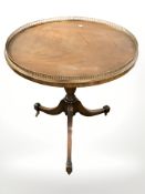 A reproduction mahogany tripod table with galleried top, diameter 59 cm.