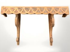 A carved pine wall shelf, width 69 cm.