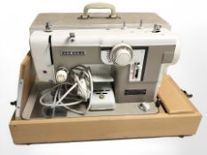 A New Home electric sewing machine, with lead and pedal.