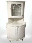 A painted and glazed corner cabinet.