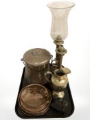 A pair of brass candlesticks, one with glass shade,