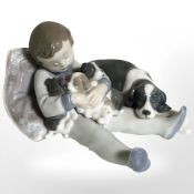 A Lladro figure of a boy with puppies, No. 1535.