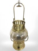 A brass and glass ships oil lamp, height 58 cm including handle.