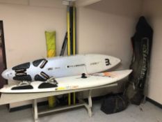 A collection of wind surfing equipment including two boards, two adjustable booms, 2 x 2 pc masts,
