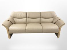 A continental cream leather three seater settee, width 223 cm.