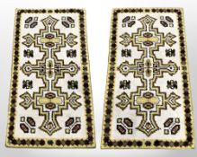 A pair of 1970s woolen rugs, each 75 cm x 135 cm.
