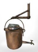 A copper bucket with brass tap, with wall mounting bracket,