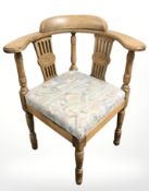 An oak corner armchair and further ebonised chair