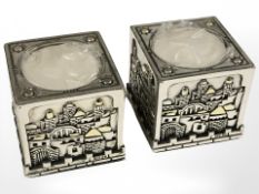 A pair of decorative silver overlaid tea light holders, height 5 cm.
