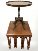 A reproduction mahogany nest of tables and a further oval occasional table.