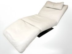 A cream leather Natuzzi leather chaise longue on chrome support,