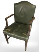 A mahogany framed green leather upholstered armchair.