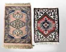 Two small Eastern rugs, each approximately 45 cm x 60 cm.