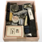 A small tray of lighters, pocket knives, pill boxes, cutthroat razors, etc.