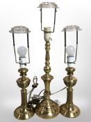 Three brass table lamps (continental plugs) and a turned wooden occasional table with polished